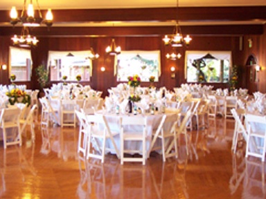 Tables and chairs arranged for an event in a ballroom